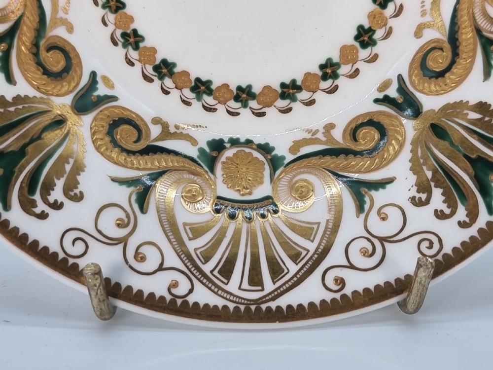 An early 19th-century Spode porcelain cabinet trio consisting of a teacup, coffee cup, and saucer adorned with intricate gold gilding and green scrollwork. View VI