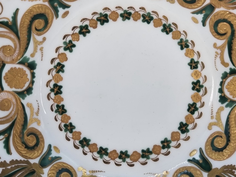 An early 19th-century Spode porcelain cabinet trio consisting of a teacup, coffee cup, and saucer adorned with intricate gold gilding and green scrollwork. View VII