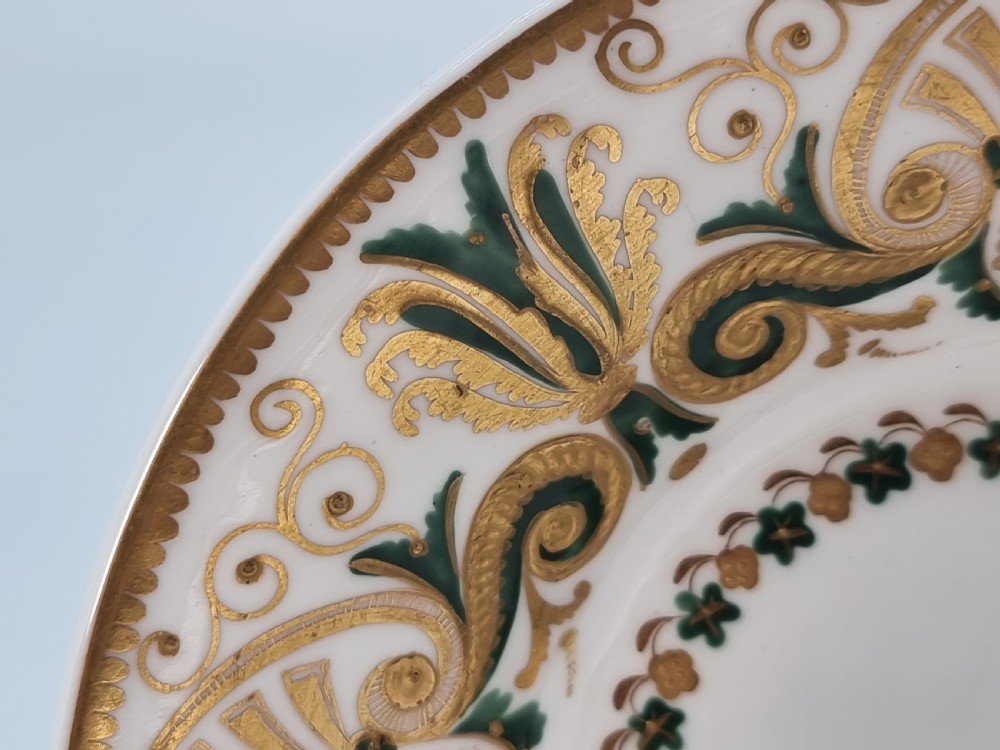 An early 19th-century Spode porcelain cabinet trio consisting of a teacup, coffee cup, and saucer adorned with intricate gold gilding and green scrollwork. View VIII