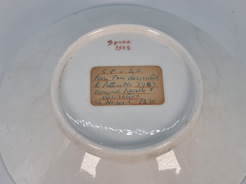 An early 19th-century Spode porcelain cabinet trio consisting of a teacup, coffee cup, and saucer adorned with intricate gold gilding and green scrollwork. View IX