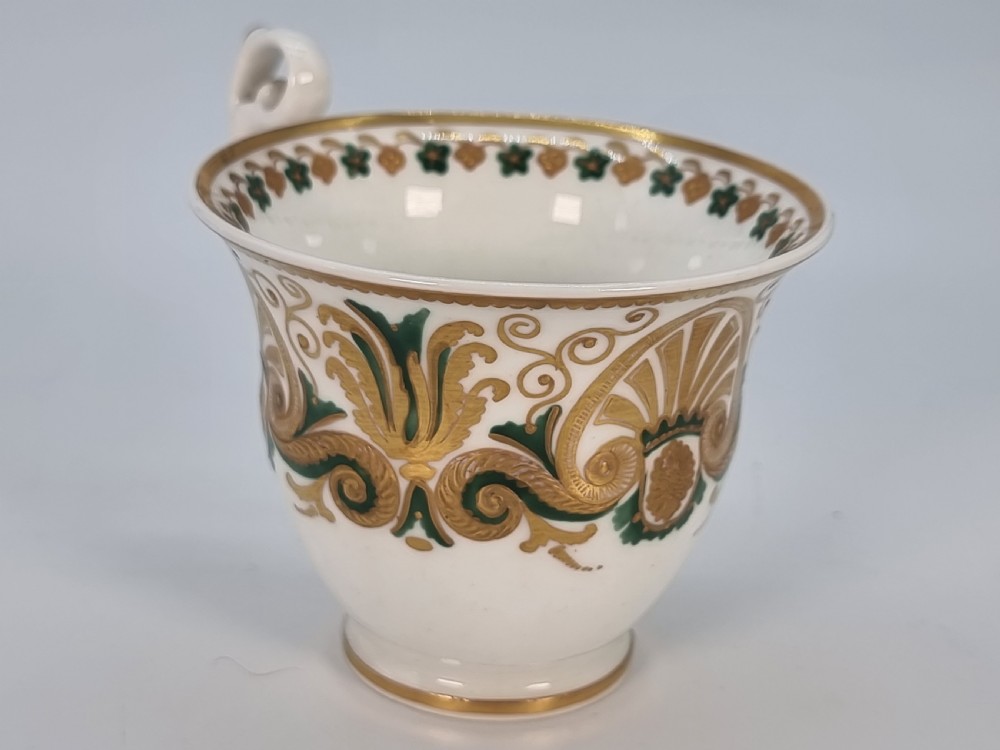 An early 19th-century Spode porcelain cabinet trio consisting of a teacup, coffee cup, and saucer adorned with intricate gold gilding and green scrollwork. View XII