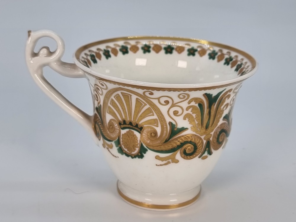 An early 19th-century Spode porcelain cabinet trio consisting of a teacup, coffee cup, and saucer adorned with intricate gold gilding and green scrollwork. View XIII