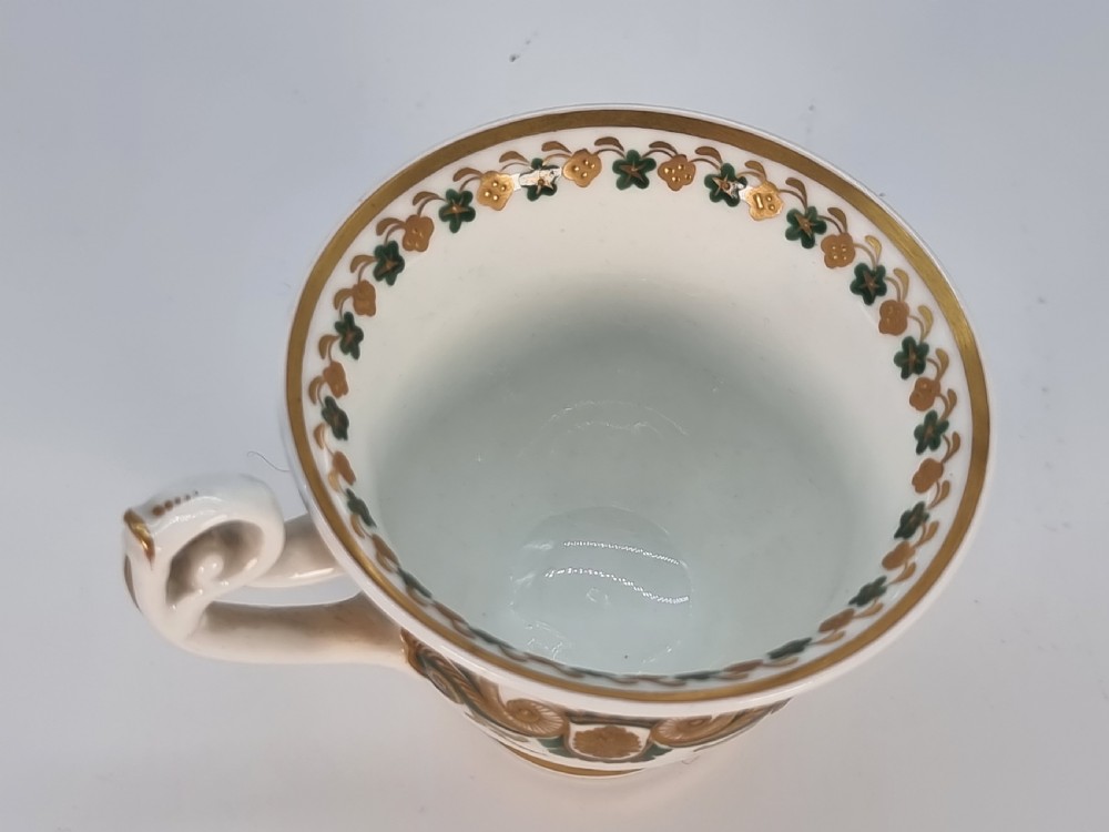 An early 19th-century Spode porcelain cabinet trio consisting of a teacup, coffee cup, and saucer adorned with intricate gold gilding and green scrollwork. View XVI