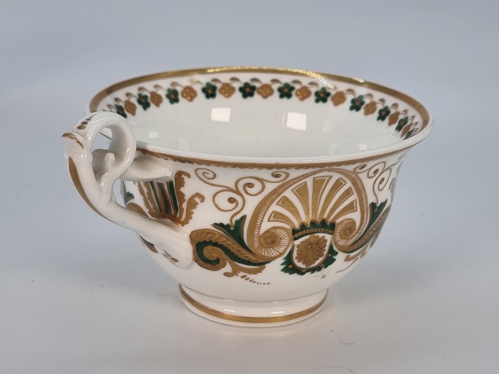 An early 19th-century Spode porcelain cabinet trio consisting of a teacup, coffee cup, and saucer adorned with intricate gold gilding and green scrollwork. View XXII