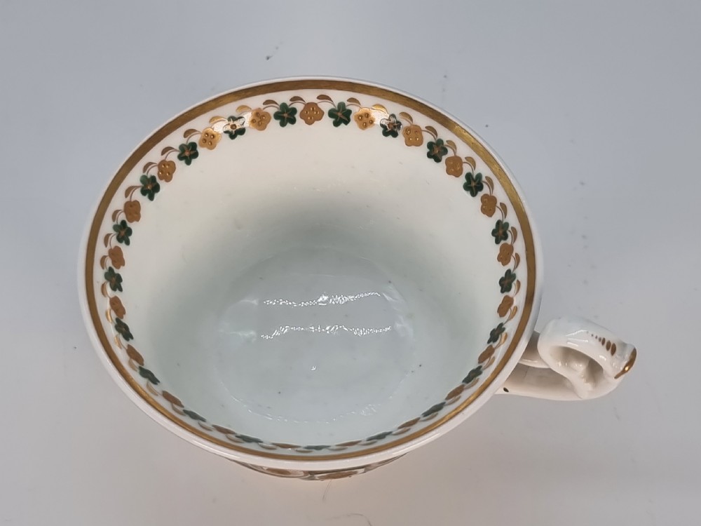 An early 19th-century Spode porcelain cabinet trio consisting of a teacup, coffee cup, and saucer adorned with intricate gold gilding and green scrollwork. View XXIII
