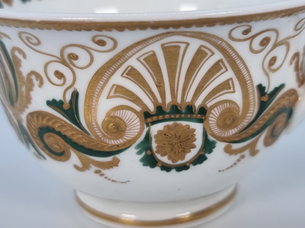 An early 19th-century Spode porcelain cabinet trio consisting of a teacup, coffee cup, and saucer adorned with intricate gold gilding and green scrollwork. View XXIV
