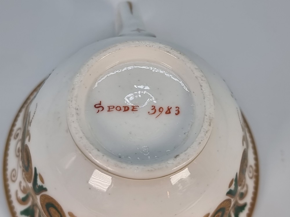 An early 19th-century Spode porcelain cabinet trio consisting of a teacup, coffee cup, and saucer adorned with intricate gold gilding and green scrollwork. View XXV