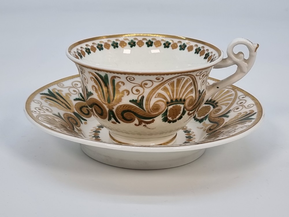 An early 19th-century Spode porcelain cabinet trio consisting of a teacup, coffee cup, and saucer adorned with intricate gold gilding and green scrollwork. View XXVII