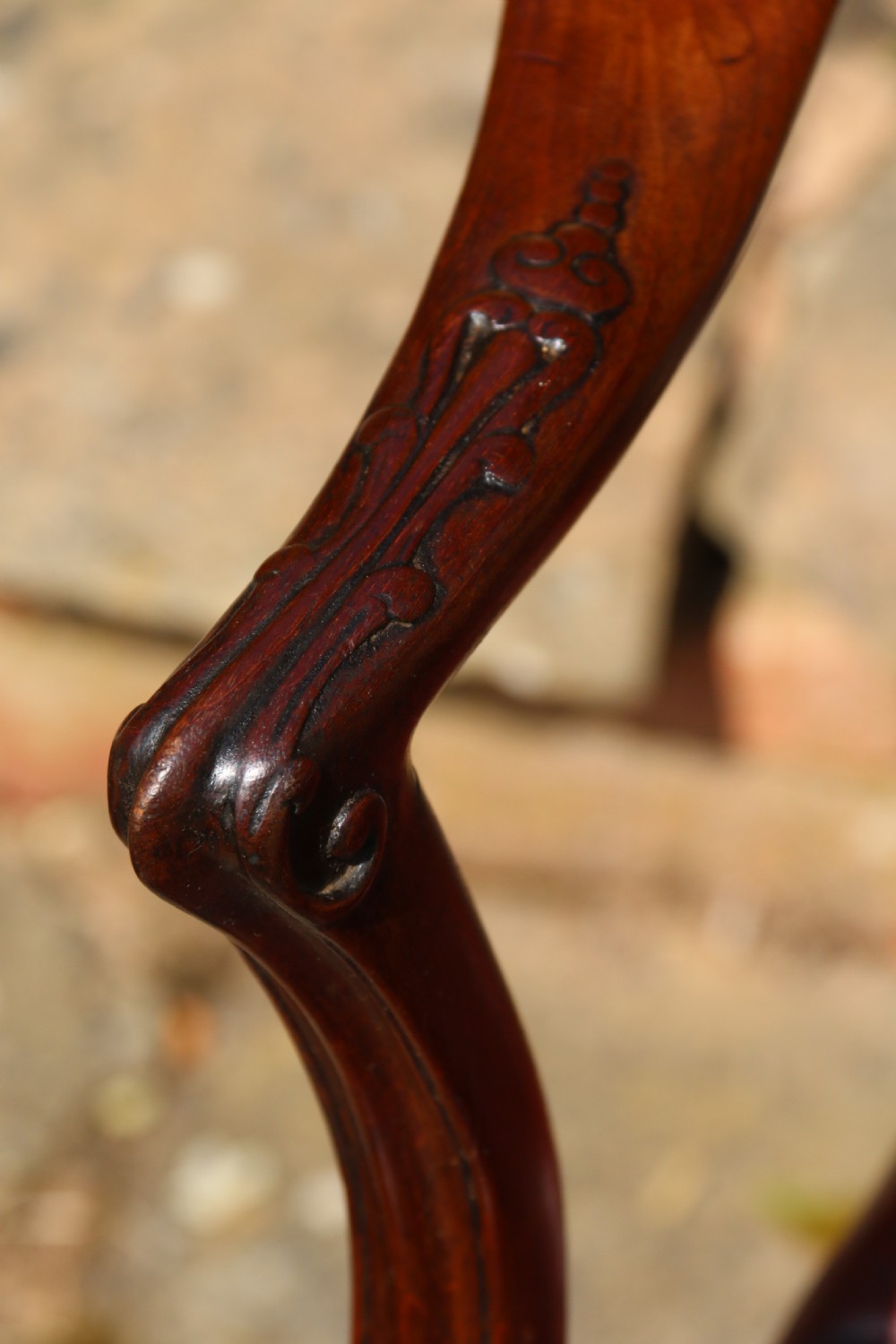 A pair of 18th-century George III Chippendale period mahogany armchairs featuring pierced carved back splats and deep red buttoned leather seats with brass stud trim. View XIII