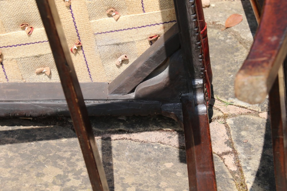 A pair of 18th-century George III Chippendale period mahogany armchairs featuring pierced carved back splats and deep red buttoned leather seats with brass stud trim. View XXI