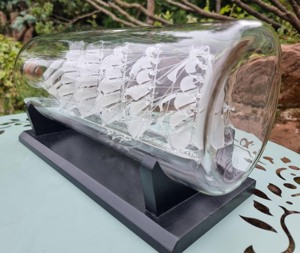 An exceptionally large hand blown glass model ship in a bottle. View III