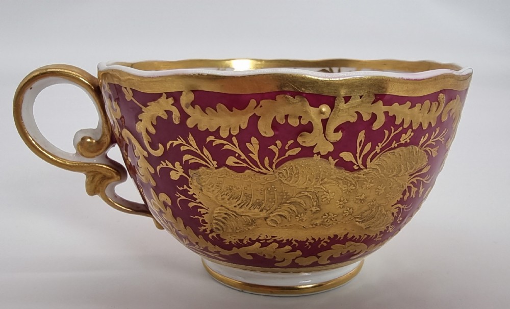 An early nineteenth-century Spode cabinet cup and matching saucer featuring a deep magenta ground embellished with heavy gold leaf scrollwork. View XIII