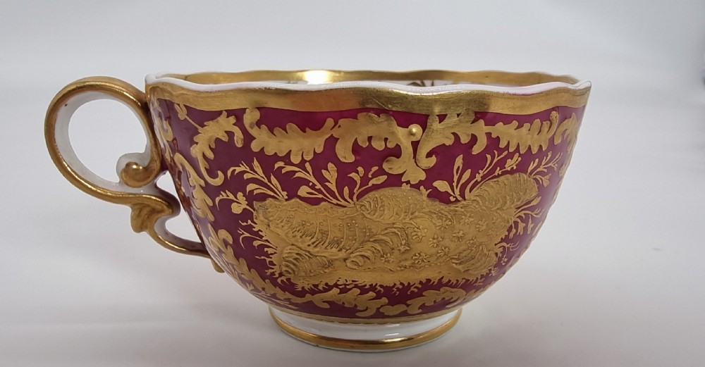 An early nineteenth-century Spode cabinet cup and matching saucer featuring a deep magenta ground embellished with heavy gold leaf scrollwork. View XIV