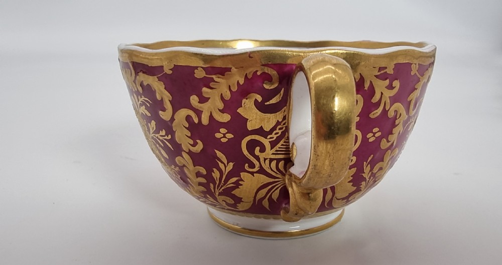 An early nineteenth-century Spode cabinet cup and matching saucer featuring a deep magenta ground embellished with heavy gold leaf scrollwork. View XVI