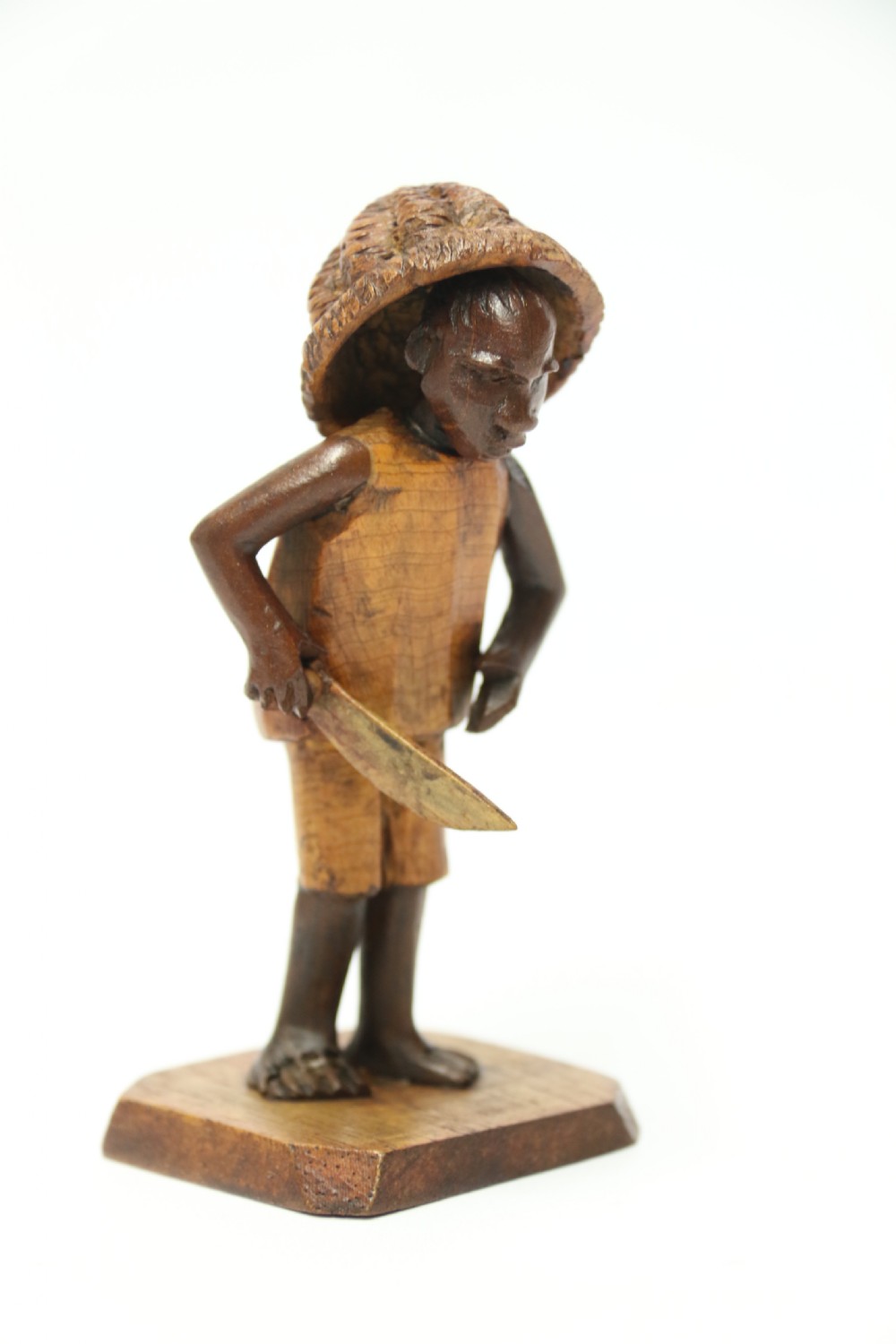 A collection of hand-carved warm brown hardwood figures from Nigeria depicting individuals engaged in daily tasks alongside a carved canoe. View X