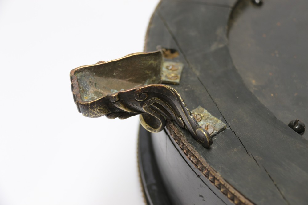 An antique French roulette wheel with ebonised wood casing and brass claw feet, set in front of an original dark green felt layout cloth printed with gold French gaming text. View IV