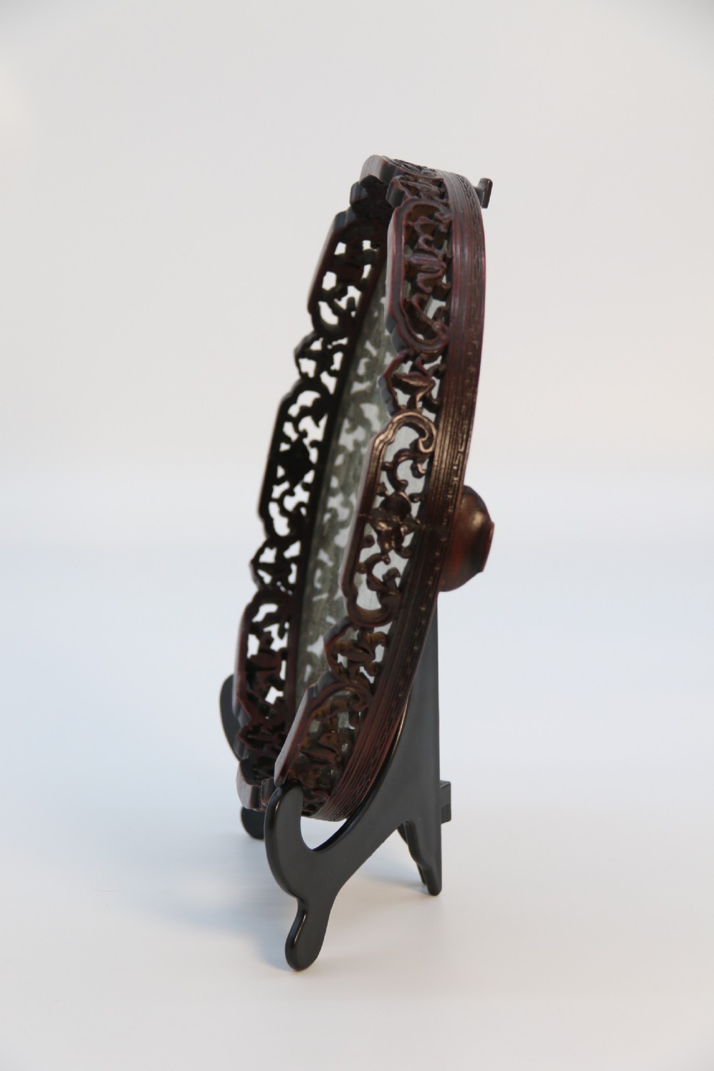 A circular carved dark hardwood tray containing an inset 19th-century Chinese silk embroidery with figural and botanical motifs. View IV