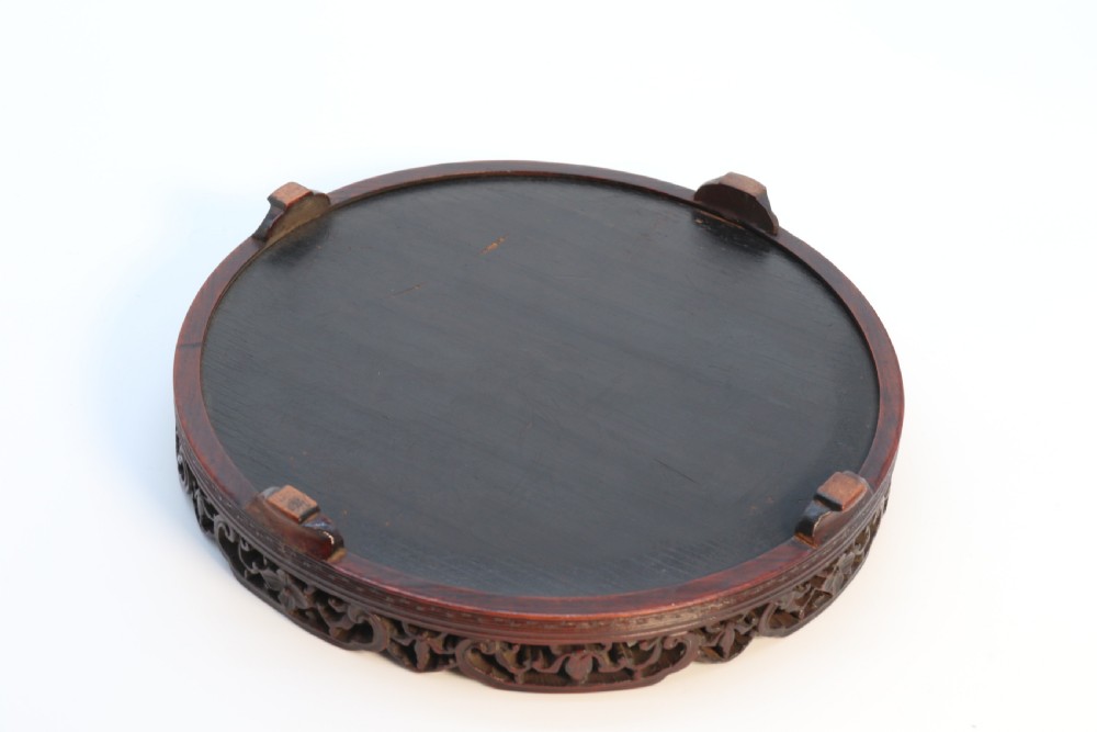 A circular carved dark hardwood tray containing an inset 19th-century Chinese silk embroidery with figural and botanical motifs. View XI