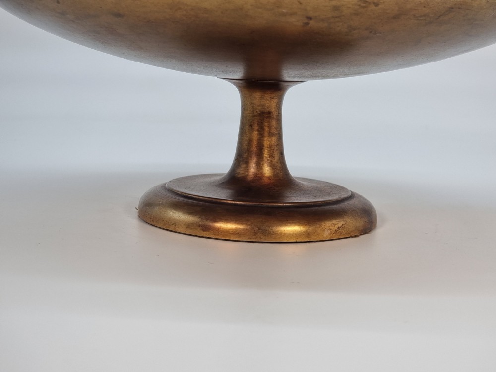 An Aesthetic Movement circular gilt metal tazza on a pedestal foot featuring ornate foliate scrollwork and a central relief medallion. View IX