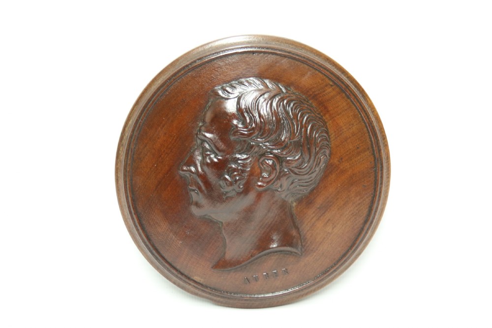 A pair of circular carved mahogany wall plaques featuring raised profile relief busts of classical composers Rossini and Auber. View III