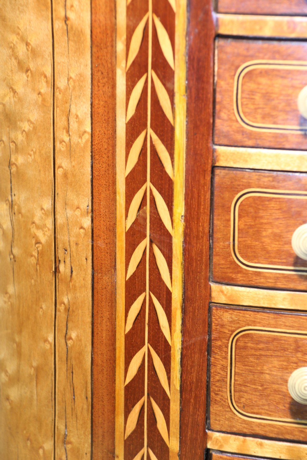 An oval George III satinwood worktable featuring marquetry inlay, multiple drawers, tapered legs, and a rising mirror compartment. View VI