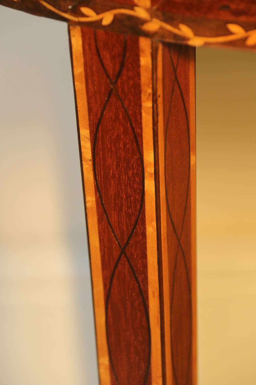 An oval George III satinwood worktable featuring marquetry inlay, multiple drawers, tapered legs, and a rising mirror compartment. View VIII