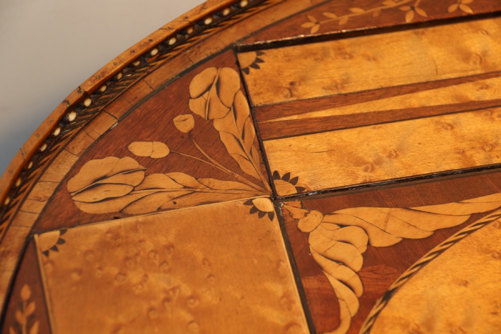 An oval George III satinwood worktable featuring marquetry inlay, multiple drawers, tapered legs, and a rising mirror compartment. View X