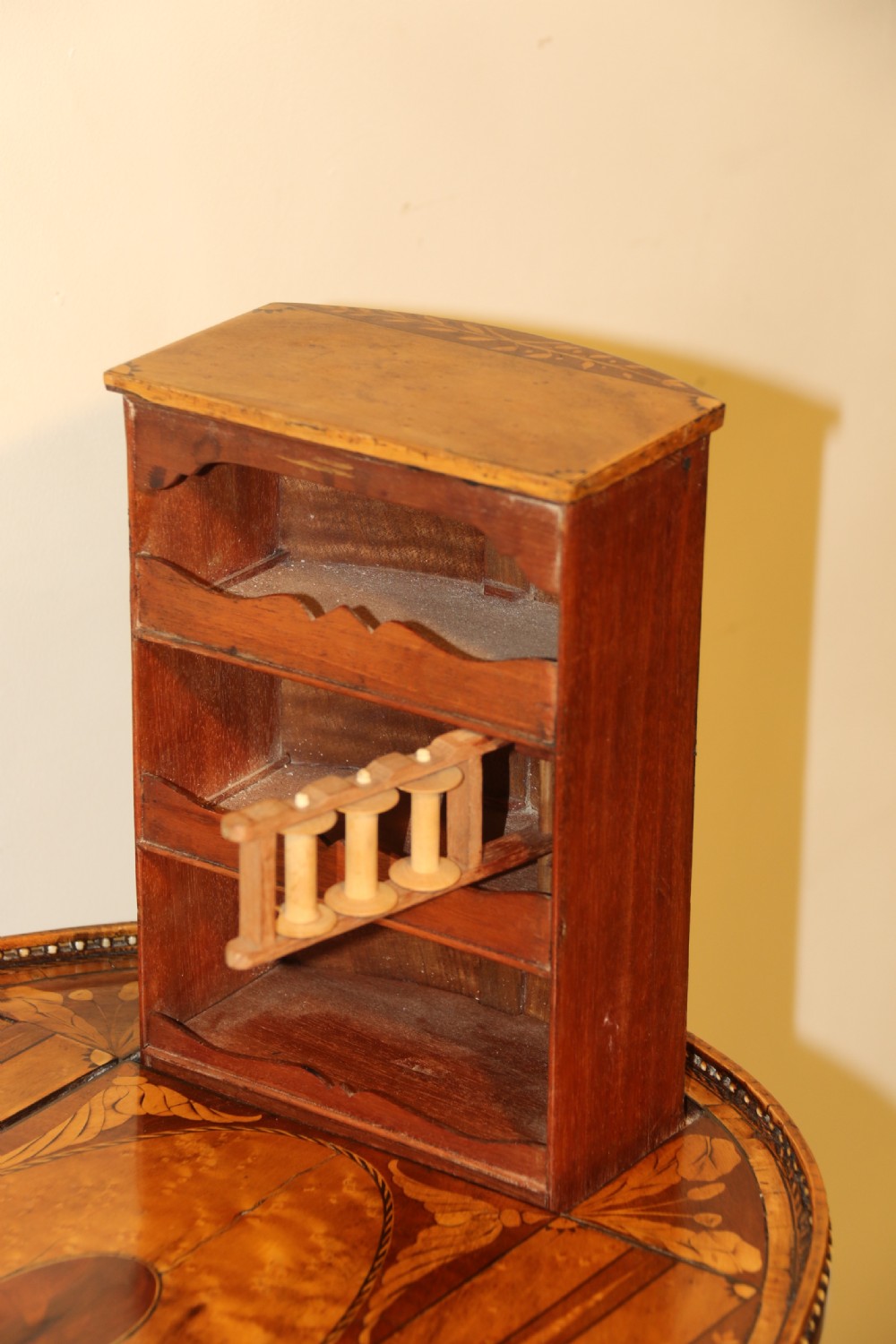 An oval George III satinwood worktable featuring marquetry inlay, multiple drawers, tapered legs, and a rising mirror compartment. View XIV