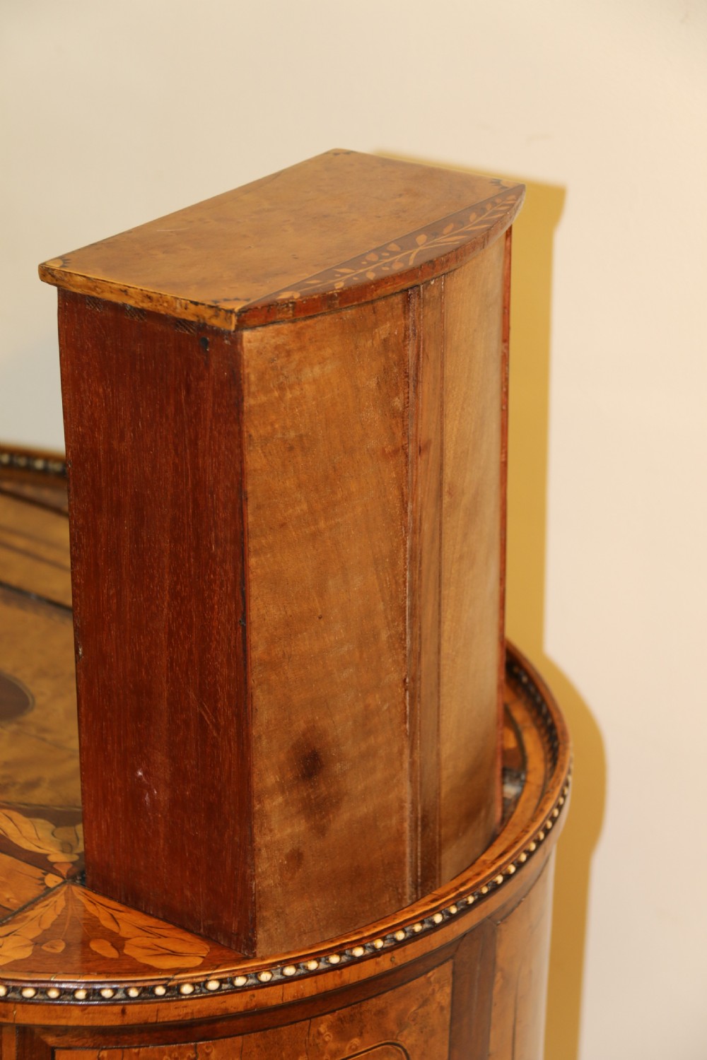 An oval George III satinwood worktable featuring marquetry inlay, multiple drawers, tapered legs, and a rising mirror compartment. View XV