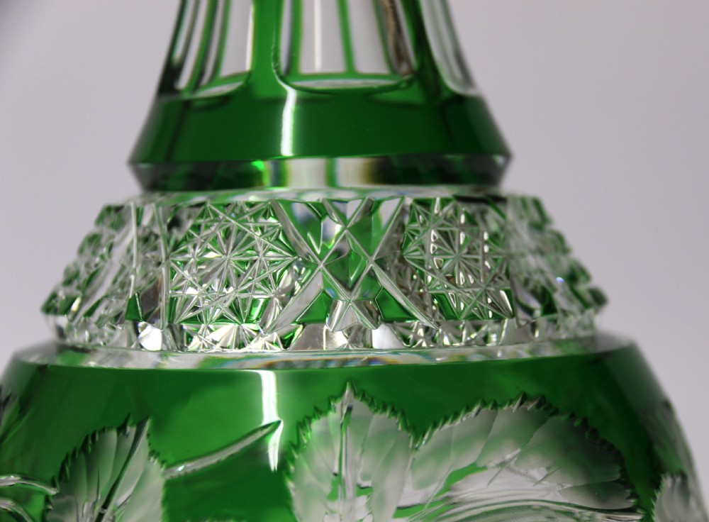A Bohemian silver topped green overlaid and deeply cut and carved glass spirit decanter. View III