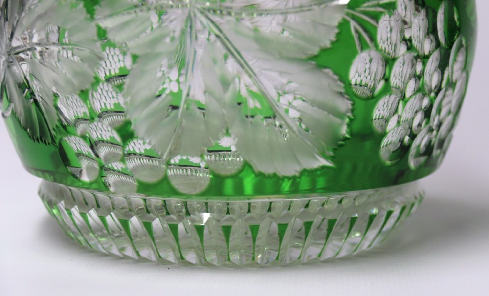 A Bohemian silver topped green overlaid and deeply cut and carved glass spirit decanter. View VI
