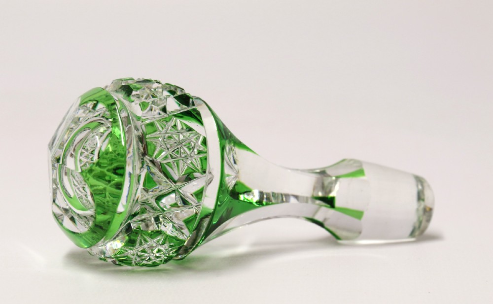 A Bohemian silver topped green overlaid and deeply cut and carved glass spirit decanter. View X