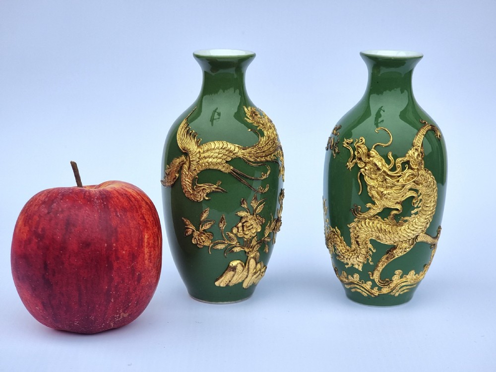 A miniature pair of Chinese porcelain and lacquer decorated vases