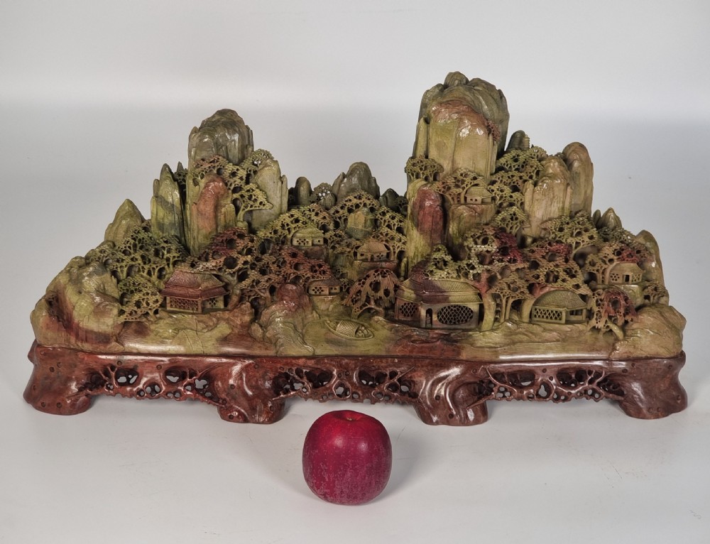 A fine Chinese carved soapstone continuous landscape of unusually large proportions