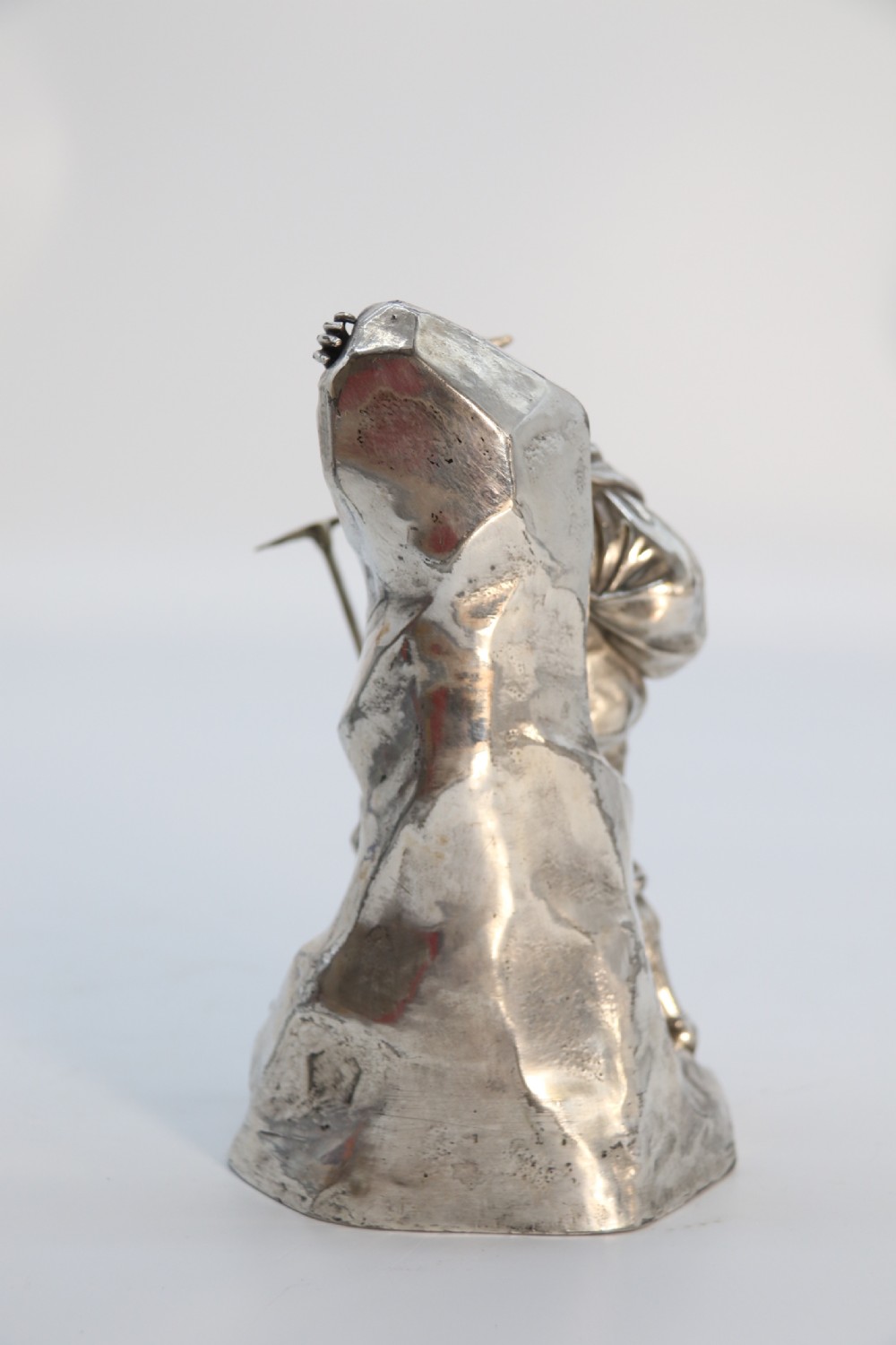 A  WMF cast metal and silver plated sculpture of an early 20th century mountaineer climbing a rock face, c 1910


 View II