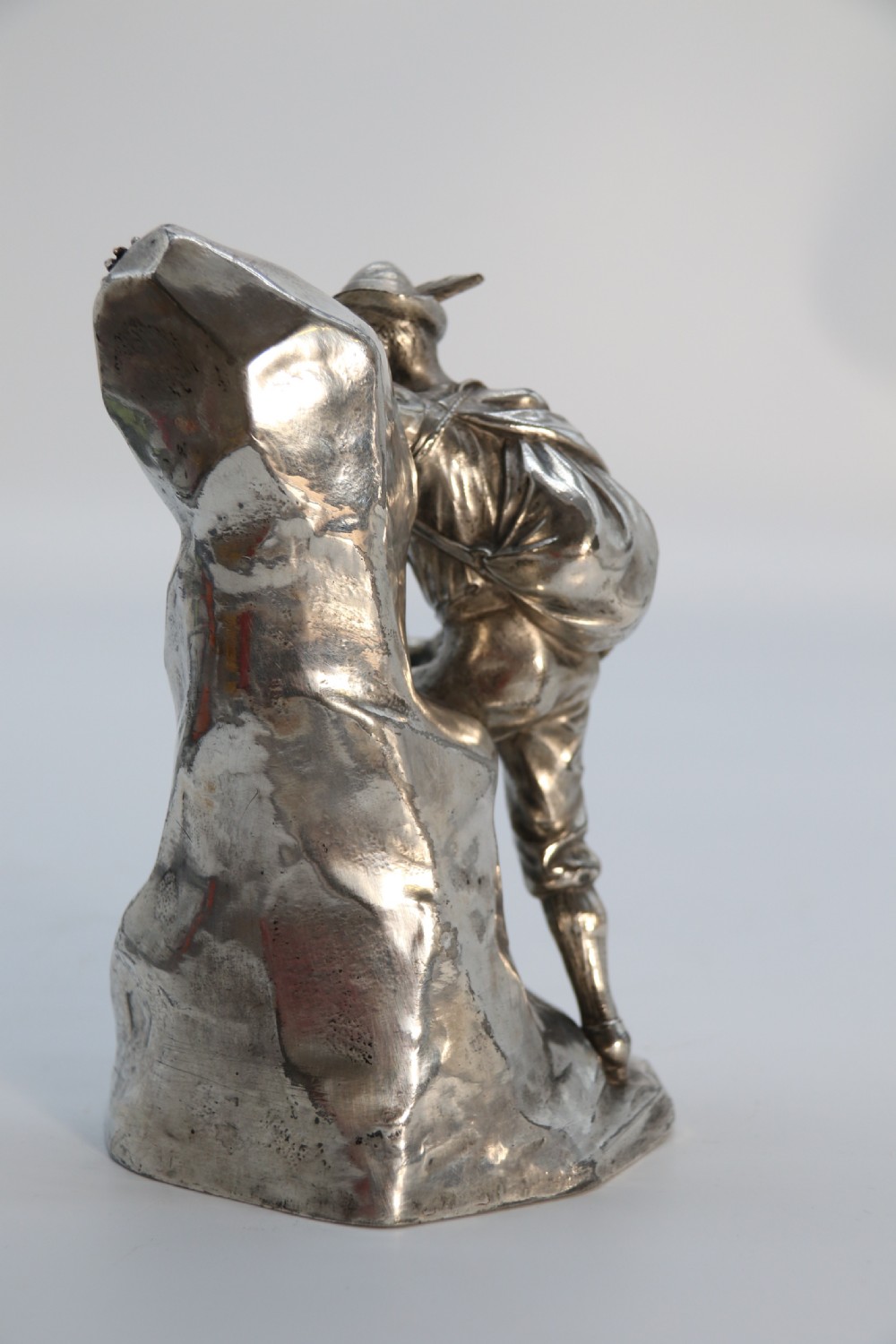 A  WMF cast metal and silver plated sculpture of an early 20th century mountaineer climbing a rock face, c 1910


 View III