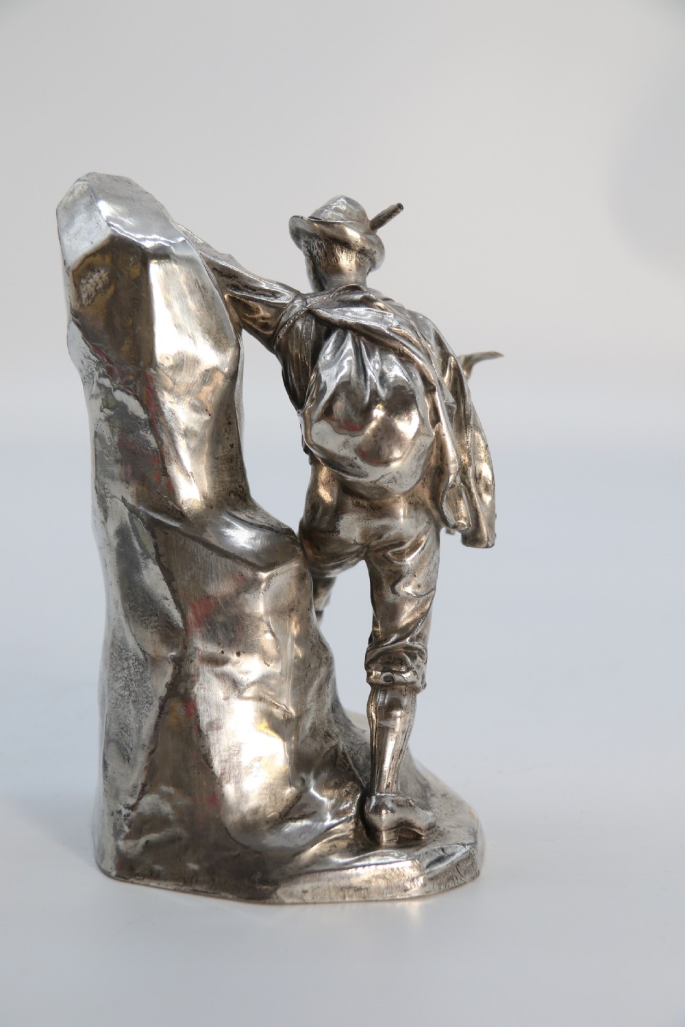A  WMF cast metal and silver plated sculpture of an early 20th century mountaineer climbing a rock face, c 1910


 View IV