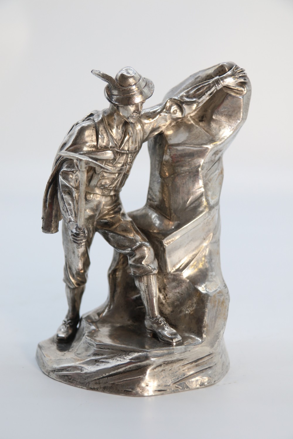 A  WMF cast metal and silver plated sculpture of an early 20th century mountaineer climbing a rock face, c 1910


 View IX