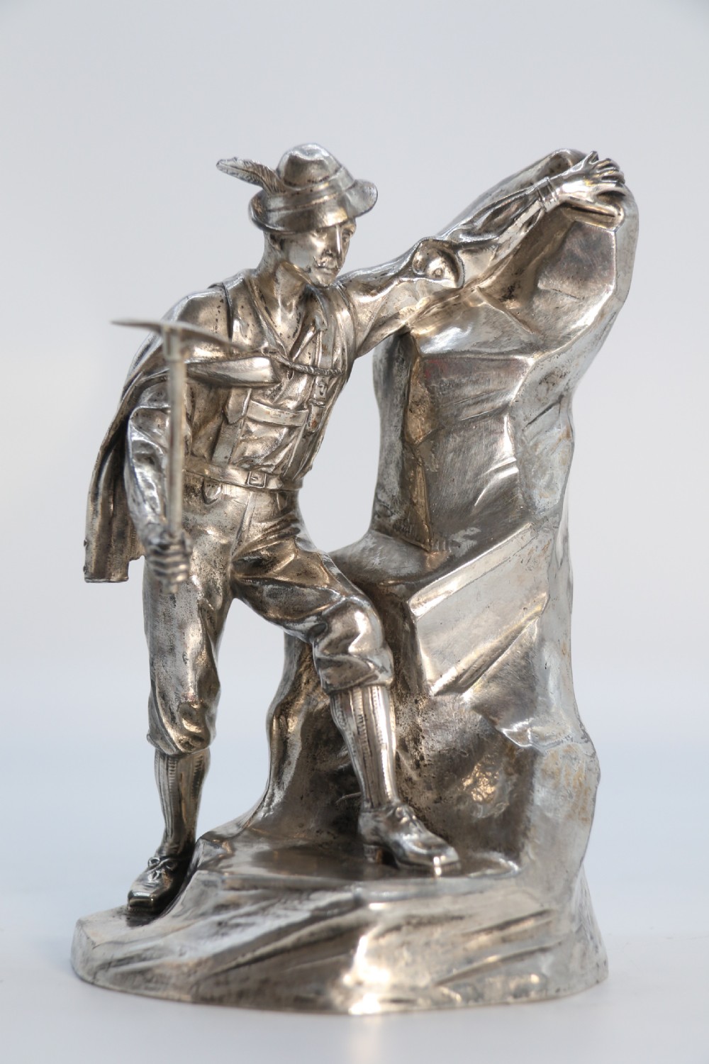 A  WMF cast metal and silver plated sculpture of an early 20th century mountaineer climbing a rock face, c 1910


 View X