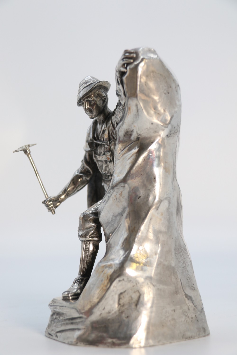 A  WMF cast metal and silver plated sculpture of an early 20th century mountaineer climbing a rock face, c 1910


 View XI