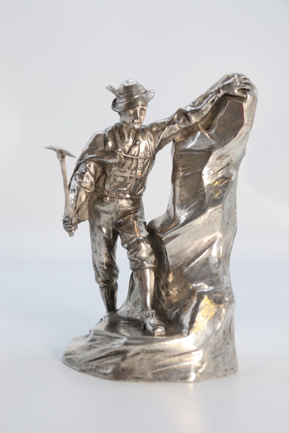 A  WMF cast metal and silver plated sculpture of an early 20th century mountaineer climbing a rock face, c 1910


 View XIV