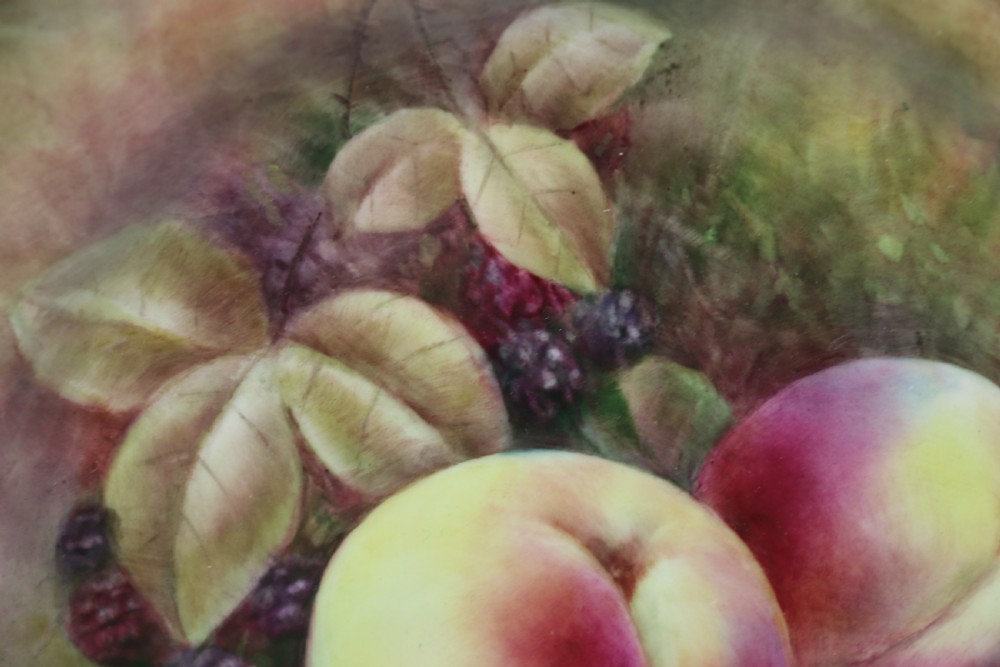 A pair of circular hand-painted porcelain plates displaying still life compositions of peaches, grapes, and blackberries framed by gilded scalloped edges. View XIII