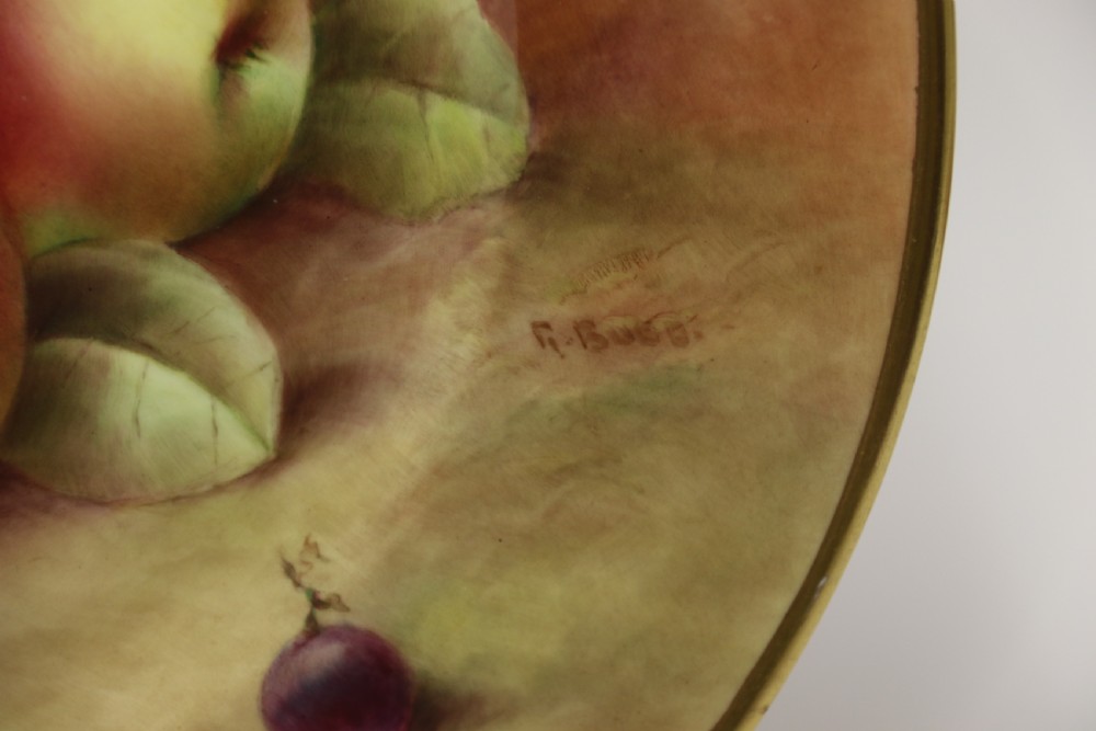 A pair of circular hand-painted porcelain plates displaying still life compositions of peaches, grapes, and blackberries framed by gilded scalloped edges. View XXII