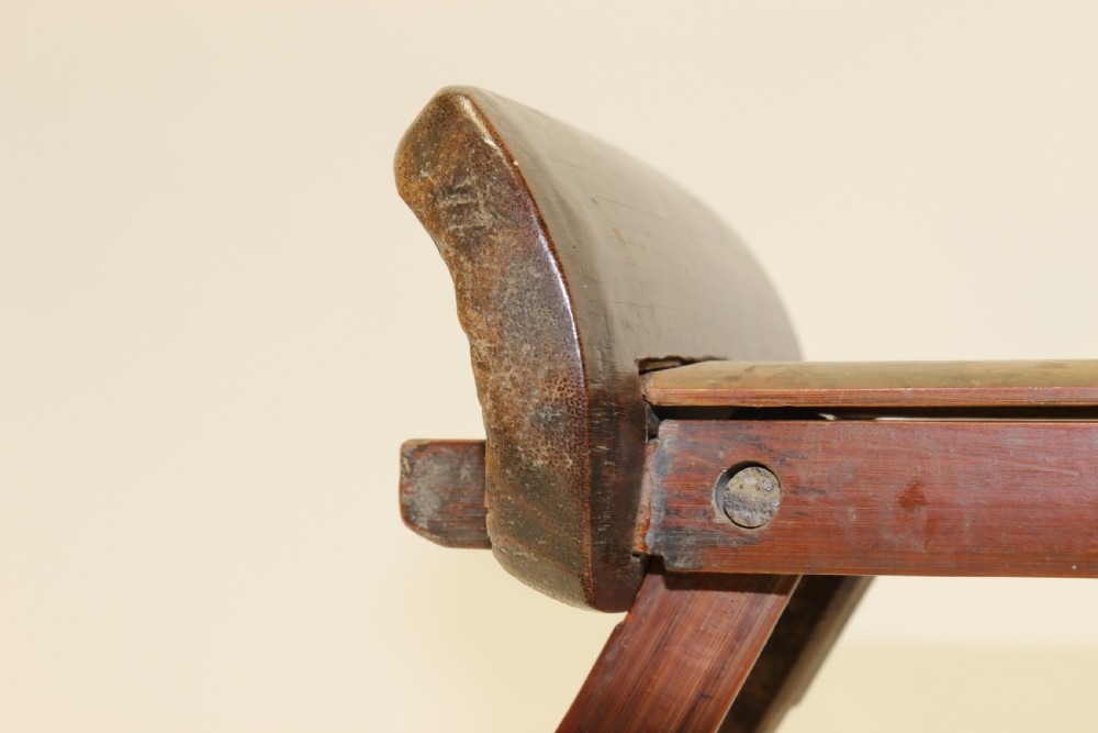 An eighteenth-century Chinese folding headrest crafted from dark bamboo and carved timber supports. View VI