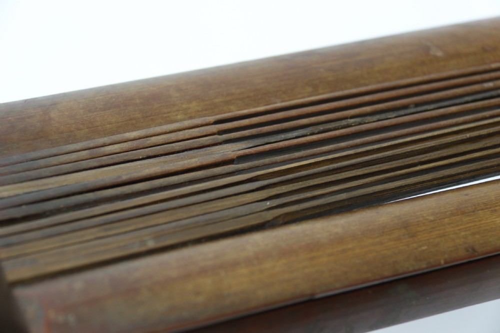 An eighteenth-century Chinese folding headrest crafted from dark bamboo and carved timber supports. View VII