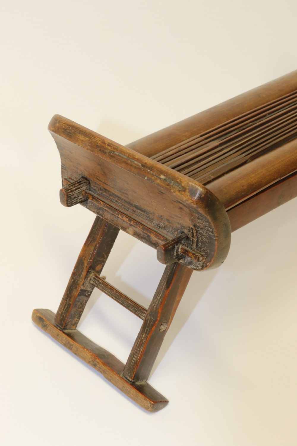 An eighteenth-century Chinese folding headrest crafted from dark bamboo and carved timber supports. View VIII