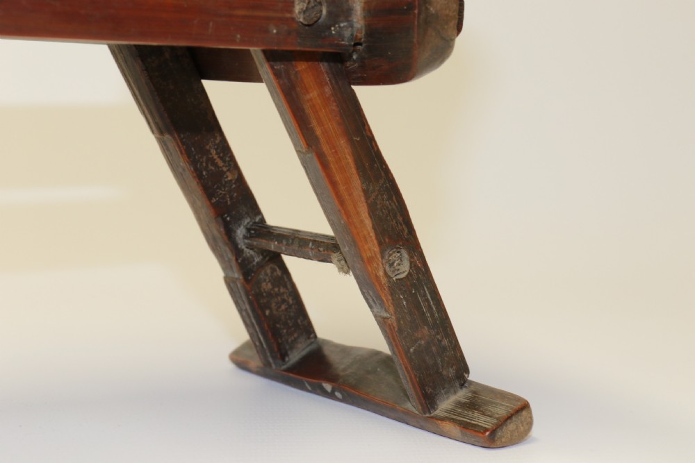An eighteenth-century Chinese folding headrest crafted from dark bamboo and carved timber supports. View XI