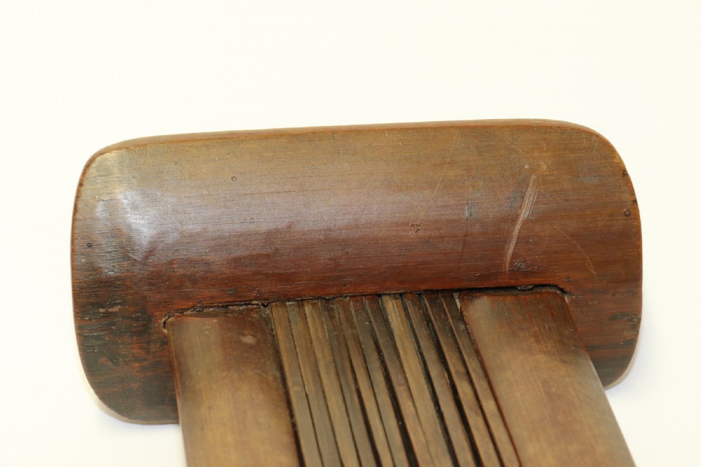 An eighteenth-century Chinese folding headrest crafted from dark bamboo and carved timber supports. View XIV