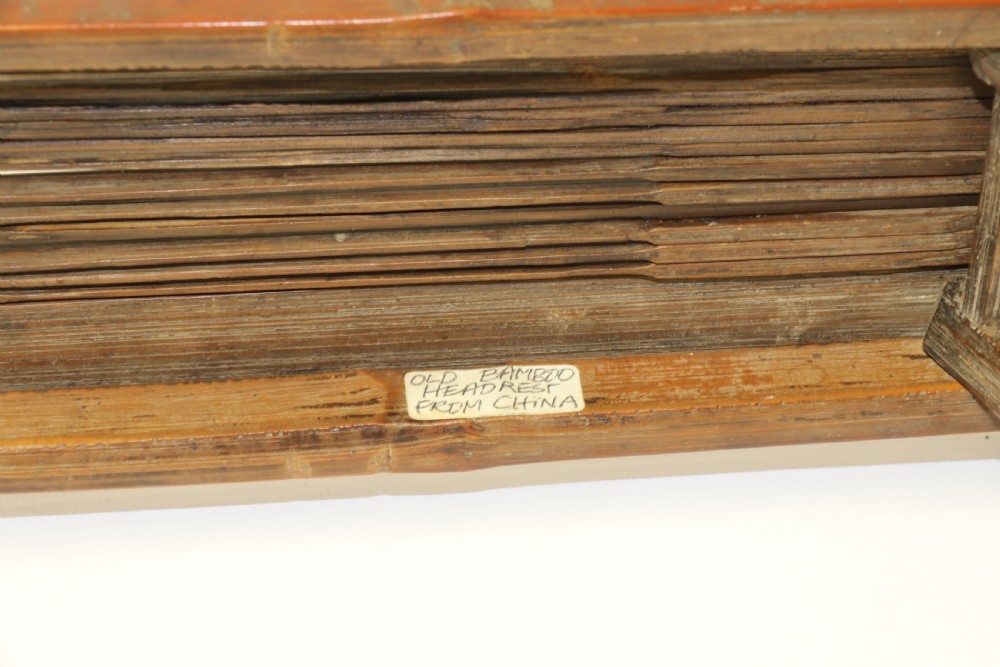 An eighteenth-century Chinese folding headrest crafted from dark bamboo and carved timber supports. View XVII