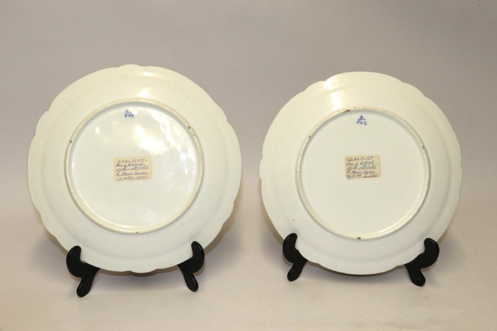 A pair of circular antique porcelain cabinet plates featuring central hand-painted floral motifs surrounded by elaborate gilded and cobalt blue borders. View XIII